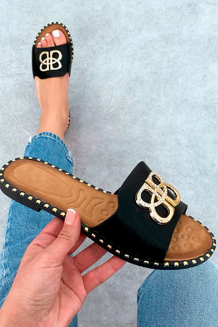 BLACK SLIP ON FLAT SANDAL WITH GOLD BUCKLE AND STUDDED SOLE DETAIL