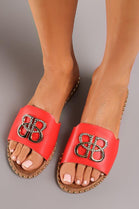 RED SLIP ON FLAT SANDAL WITH GOLD BUCKLE AND STUDDED SOLE DETAIL